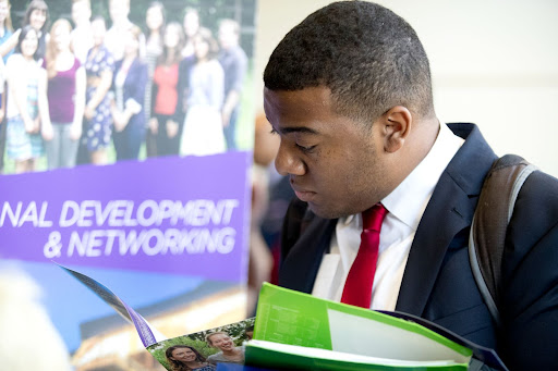 Student reading pamphlet at career fair