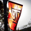 A Temple banner silhouetted by the sun.