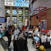 students mill about the atrium and visit tables during a student org fair
